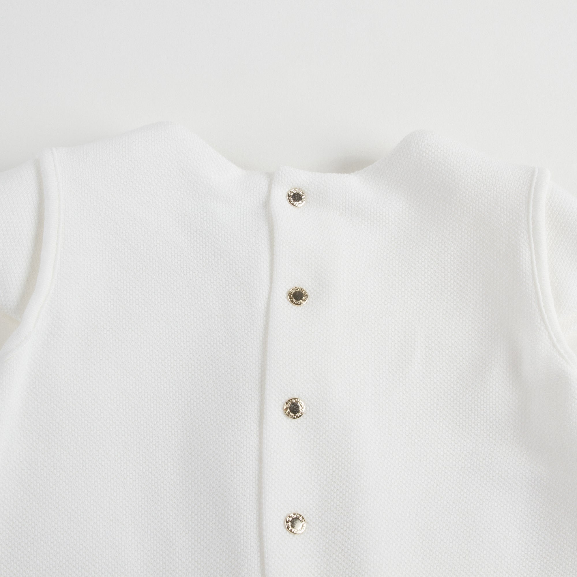 Robe bébé fille en coton blanc avec bordures en strass dorés